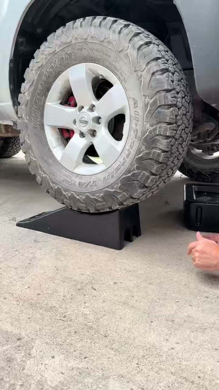 TruRamp low-profile scoop service ramps lifting a sedan in a home garage